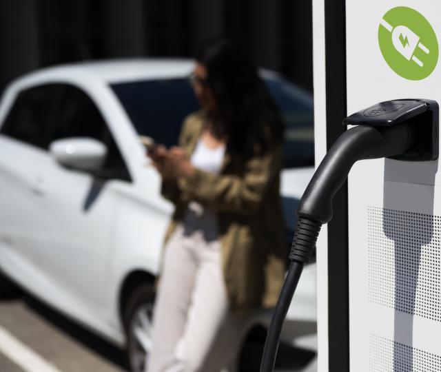 side view blurry woman waiting near car